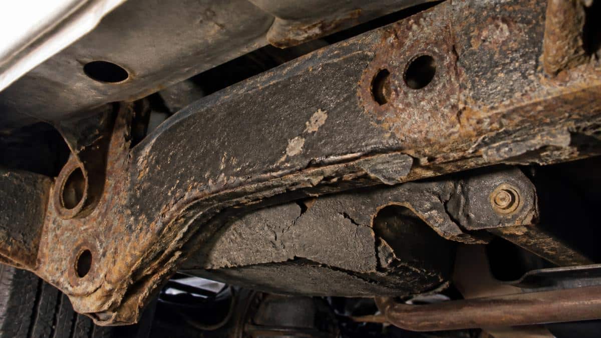 Diagram showing rust, corrosion, and peeling layers explaining why factory undercoating is insufficient.